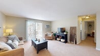 Located at 2 Robinson Rd in Rocky Hill, Connecticut, this single-floor, 2-bedroom, 1-bathroom residence offers a thoughtfully arranged layout that maximizes functionality across its compact footprint. Neutral-toned walls and wall-to-wall carpeting throughout the main living areas create a cohesive, understated aesthetic.

The combined living and dining area serves as the social heart of the home. The living room features a sliding glass door that opens to a private balcony, allowing natural light to fill the space and providing outdoor access. The dining area is defined by an elegant chandelier overhead, adding a refined touch. Together, these spaces offer a comfortable, open feel.

The kitchen features warm wood cabinetry, dark countertops, tile flooring, and white appliances including a range and refrigerator, providing generous storage and workspace in a galley-style configuration.

The primary bedroom offers a comfortable footprint with two closets and neutral carpeting. The second bedroom also features dual closets and similarly soft, neutral finishes. Both rooms are quiet and well-proportioned.

The bathroom includes a tiled tub-shower combination with clean, simple finishes. A connecting hallway efficiently links all rooms, completing this practical and comfortable layout.