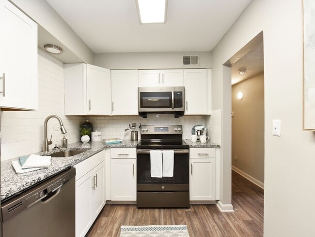 Kitchen with granite counters and stainless appliances - The Harper