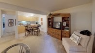 This well-appointed single-floor residence in Manchester, MO offers a thoughtfully designed layout with comfortable living spaces throughout. The living room serves as the heart of the home, featuring plush carpeting, a ceiling-height entertainment wall, and a sliding glass door that opens to a private outdoor balcony with serene tree views, filling the space with natural light.

Adjacent to the living room, the dining area provides a seamless transition, complete with a ceiling fan and direct sightlines into the kitchen. The galley-style kitchen is efficiently laid out with ample warm-toned wood cabinetry on both sides, white countertops, a full suite of appliances including a refrigerator, range, and dishwasher, and easy-care tile flooring.

The two bedrooms are carpeted and well-sized, each featuring sliding-door closets that offer generous storage. The rooms are quiet and comfortable, with windows allowing in natural light.

The bathroom is clean and functional, featuring a tub-shower combination, a single-sink vanity with cabinet storage, and neutral finishes throughout.

The overall ambiance of the space is warm and inviting, with a neutral color palette, consistent carpeting in living areas, and a practical flow that connects each room naturally.