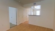 This two-floor residential space offers a functional and well-maintained layout designed for comfortable everyday living. The interior is finished with warm hardwood-style flooring that extends throughout the main living areas, complemented by crisp white trim, clean white doors, and neutral beige walls that create a bright, cohesive atmosphere.

A standout feature of the main level is the pass-through opening between the kitchen and the adjoining living area. Framed by a dark-topped counter, this architectural detail enhances the sense of openness and connectivity between spaces while allowing natural light from the kitchen window to filter into the hallway and living area.

The entryway and hallway area provide access to multiple rooms through classic six-panel white doors, offering a practical and organized flow through the space. Overhead lighting fixtures are recessed and flush-mounted, maintaining a clean ceiling line. Ventilation is well integrated with visible ceiling vents positioned throughout.

The overall ambiance of the space is understated and functional, with a neutral palette that offers a versatile canvas for personalization. The layout across two floors provides separation between living and private areas, making it a well-structured space suited for a variety of occupants.