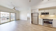 Located at 1545 Wigwam Parkway in Henderson, Nevada, this well-appointed 2-bedroom, 2-bathroom unit offers a clean, modern aesthetic throughout. Light wood-style flooring flows across the open-concept living, dining, and kitchen area, creating a bright and cohesive common space. The kitchen is equipped with stainless steel appliances — including a refrigerator, range, microwave, and dishwasher — complemented by white cabinetry, a tile backsplash, and track lighting overhead. The living area is fitted with a ceiling fan and features a sliding glass door that opens to a private balcony with outdoor views. Both bedrooms are carpeted and bathed in natural light from well-positioned windows with blinds. The spacious primary bedroom includes its own closet access. The two bathrooms feature light wood-style flooring, modern vanities with light-colored countertops, and clean, neutral finishes. A dedicated laundry area and an impressive seven closets provide exceptional storage throughout the unit. Hallways connect the space efficiently, and the overall design maintains a bright, neutral palette that lends a fresh, contemporary feel to every room.