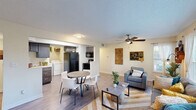 Located at 800 Alexander Rd in Cayce, SC, this single-floor unit offers five bedrooms and four bathrooms across a well-organized layout. The inviting living room features wood-look flooring, a textured ceiling, a ceiling fan, and large windows that flood the space with natural light and offer outdoor views. The kitchen is equipped with rich gray shaker-style cabinetry, marble-look countertops, a stainless steel sink, and a dishwasher — combining style with everyday functionality. Each bedroom is carpeted for comfort and includes a ceiling fan and a closet with sliding or panel doors. The bedrooms are versatile, accommodating both sleeping and workspace needs, with windows providing natural light. The four bathrooms are clean and modern, each featuring a walk-in shower with glass doors and built-in corner shelving. A dedicated laundry area houses a full-size side-by-side GE washer and dryer with overhead wire shelving for additional storage. Two hallways connect the rooms efficiently throughout the layout. The overall ambiance is bright, functional, and well-appointed, making this unit an excellent option for shared or multi-occupant living in the Cayce area.