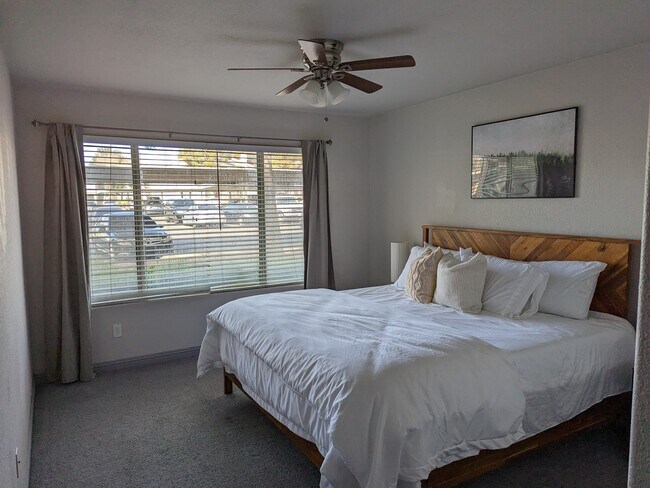 Fully furnished master bedroom with king sized bed and bright windows. - 3182 Tarpon