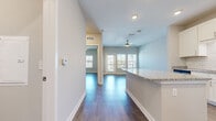 Located at 1701 Rinehart Rd in Sanford, FL, this thoughtfully designed one-bedroom, one-bathroom residence offers a comfortable and modern living experience across a single floor. Wood-style flooring flows throughout, lending warmth and visual continuity to the space.

The open-concept kitchen and living area serves as the heart of the home. The kitchen is outfitted with crisp white shaker cabinets, granite countertops, a classic white subway tile backsplash, a granite-topped center island, and a full suite of stainless steel appliances. A ceiling fan overhead and glass-paneled door leading to a private balcony bring natural light and outdoor views into the living area.

The bedroom is a well-sized, tranquil retreat featuring wood-style flooring, a ceiling fan, and dual windows that fill the room with natural light. An en-suite bathroom includes a soaking tub with vertically-laid white tile surround, offering a clean, contemporary aesthetic. A dedicated closet and separate laundry room with full-size Whirlpool washer and dryer add practical convenience to the layout.

Neutral wall tones, recessed lighting, and clean architectural lines throughout create a bright, cohesive ambiance that is both functional and inviting.