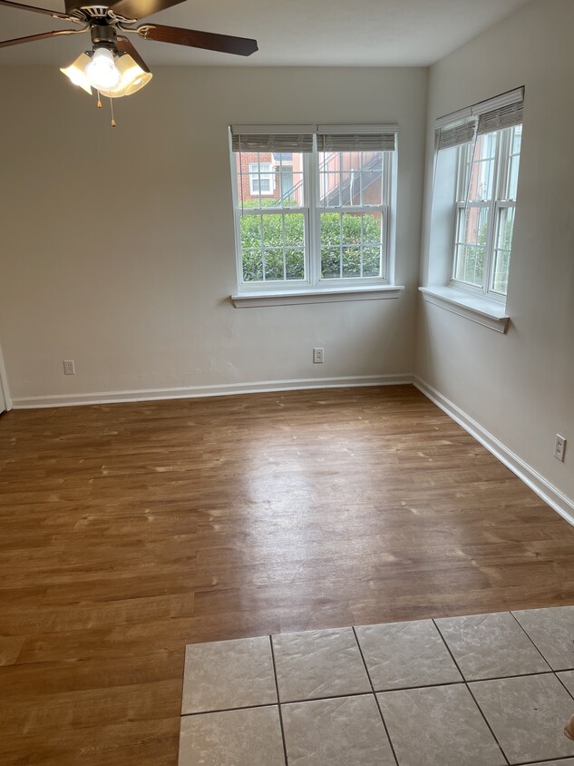 Large living space with ceiling fan and natural light - 2000 Central Ave