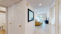 Located at 380 Brazilian Cir in Port Saint Lucie, FL, this single-floor, one-bedroom, one-bathroom residence offers a well-organized and bright layout. Light-toned tile flooring flows throughout the main living areas, lending a clean, cohesive look to the space.

The kitchen is outfitted with white cabinetry extending to the ceiling for ample storage, white appliances including a range and refrigerator, a dishwasher, and a peninsula that provides both additional counter space and a casual seating area. The adjacent dining area is highlighted by a decorative chandelier and a window with an outdoor view, filling the space with natural light. The living room connects seamlessly to a sliding glass door that opens to the outdoors, with a ceiling fan overhead enhancing airflow and comfort.

The primary bedroom is generously proportioned, featuring plush carpeting, a ceiling fan, natural light through a window with vertical blinds, and dual closets offering substantial storage. The full bathroom is finished in neutral tones with light tile flooring, a vanity with white cabinetry, and a tub/shower combination. Two hallways and a dedicated entrance complete the functional, efficiently designed floor plan of this Port Saint Lucie residence.