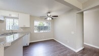 Located at 2401 W Roberta Ave in Fullerton, CA, this single-level residence offers a well-organized 1-bedroom, 2-bathroom layout designed for comfortable everyday living. Wood-look flooring flows consistently throughout, lending a cohesive and modern feel to every room.

The living room is bright and open, featuring a sliding glass door with vertical blinds that leads directly to a private patio, allowing natural light to fill the space. Adjacent to the living area, a dedicated dining space connects seamlessly to the galley-style kitchen. The kitchen is outfitted with white cabinetry, granite-style countertops, a gas range, and a stainless steel sink, offering practical functionality in a clean, efficient layout.

The bedroom provides a comfortable retreat with two closets, including a walk-in closet with built-in shelving, and a window overlooking the outdoors. A ceiling fan in the dining area enhances air circulation throughout the common areas.

The two bathrooms are well-appointed: one features a full tub/shower combination, while the other includes a vanity with granite-style countertops, a framed mirror, and ample drawer storage. Both maintain the consistent neutral color palette and wood-look flooring found throughout the home. Two additional closets provide generous storage capacity for the overall footprint of this Fullerton residence.