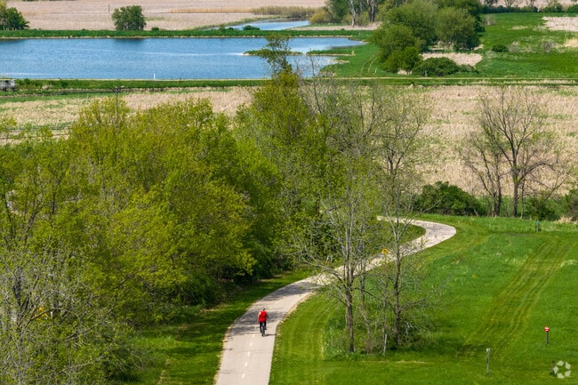 Part of the paved path at Lake Farm County Park winds past ponds and a campground.