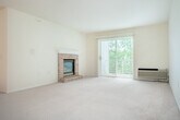 Located at 3117 Stratton Way in Madison, WI, this single-floor, one-bedroom, one-bathroom unit offers a well-organized and functional layout. The combined kitchen and living room forms the heart of the home, featuring soft carpeting, neutral cream-toned walls, and a charming brick fireplace that serves as a focal point. A sliding glass door floods the living area with natural light and opens to a private patio overlooking a serene, tree-lined green space — a standout feature of the unit. The kitchen is connected via a breakfast bar-style pass-through, complemented by a dedicated pantry for additional storage. The bedroom is a comfortable, well-proportioned retreat with carpeted flooring, a ceiling fan, a wall-mounted AC unit, and a natural light-filled window. It connects to two closets, providing ample storage. The full bathroom is finished with tile flooring, a tub-shower combination, a single-sink vanity with a large mirror, and warm overhead lighting. Additional practical features include a dedicated laundry area and a hallway that connects the spaces cohesively. The overall ambiance is clean, bright, and move-in ready.