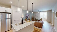 Located at 4408 N Church St in Greensboro, NC, this single-story, 2-bedroom, 2-bathroom home offers a thoughtfully designed open-concept layout with modern finishes throughout. Light hardwood flooring flows through the main living areas, complementing the soft, neutral color palette that creates a bright and cohesive atmosphere.

The kitchen is a standout feature, showcasing white shaker cabinets with matte black hardware, granite countertops, a large island with an undermount sink and a striking black gooseneck faucet, stainless steel appliances, and pendant lighting overhead. A stainless steel wall-mounted range hood adds a sleek, functional touch.

The open living and dining area provides a comfortable, versatile space with a ceiling fan and room for both relaxing and entertaining. The primary bedroom offers a generous footprint with plush carpet, large windows for natural light, a ceiling fan, and dedicated closet space. The second bedroom, also carpeted with a ceiling fan and ample natural light, provides flexibility for guests or a home office. Both bedrooms include closets.

The primary bathroom features a glass-enclosed walk-in shower with a built-in bench and granite vanity. The second bathroom offers a tub-shower combination with clean, classic finishes and hardwood-style flooring. Every detail in this home reflects a clean, contemporary design sensibility.