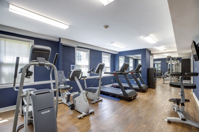 a gym with cardio equipment and treadmills at Park Crest Apartments, District of Columbia 20007 - Park Crest Apartments