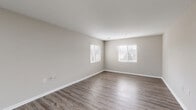 Located at 4038 Battleground Ave in Greensboro, NC, this single-floor residence offers a thoughtfully designed layout with 2 bedrooms and 2 bathrooms. The living room is a standout space, featuring wood-style luxury vinyl flooring, neutral gray-toned walls, and multiple windows dressed with white blinds that invite ample natural light into the room. The kitchen is equipped with stainless steel appliances — including a refrigerator, range, and over-the-range microwave — complemented by crisp white shaker-style cabinetry and granite-look countertops, all set atop matching wood-style flooring. A dedicated pantry provides additional storage convenience. The primary bedroom offers a comfortable footprint with plush carpet flooring, a window for natural light, and closet access. The second bedroom mirrors the clean, neutral aesthetic found throughout the home. Both bathrooms are finished with wood-style flooring consistent with the rest of the unit. A dedicated laundry area and hallway complete the efficient floor plan. Two closets provide ample storage throughout. The overall ambiance is clean, modern, and move-in ready, with a cohesive neutral palette that lends itself to a variety of interior styles.