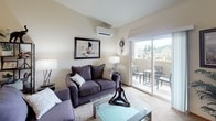 This single-floor residence at 20th Street East in Edgewood, Washington, offers a thoughtfully designed layout with a warm, neutral palette throughout. The living room serves as the heart of the home, featuring plush carpeting, a wall-mounted mini-split system for year-round comfort, and a sliding glass door that opens directly onto a private balcony—ideal for outdoor seating with neighborhood views.

The kitchen is equipped with generous counter space, a double-basin stainless steel sink, warm wood cabinetry, and light hardwood-style flooring. A pass-through opening connects the kitchen to the adjacent living area, promoting an open and connected feel. The dining area accommodates a full-sized table and is accented by overhead lighting and framed wall art.

Two well-sized bedrooms offer carpeted floors and bright windows dressed with white plantation shutters, allowing natural light while maintaining privacy. The primary bedroom features multiple windows on two walls, providing views of the surrounding community.

The bathroom presents stone-tile flooring, a vanity with warm wood cabinetry, a large mirror, and a tub-shower combination. Natural wood-toned doors are featured throughout, contributing to a cohesive and inviting interior aesthetic.