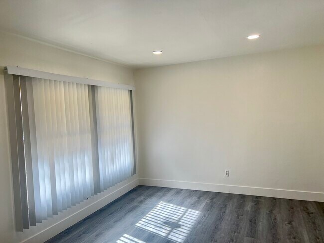 Large 2nd floor window with new vertical shades - 122 Elm Ave