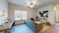 Located in North Chesterfield, Virginia, this one-bedroom, one-bathroom unit offers a well-designed, single-floor layout that maximizes every square foot. The open-concept kitchen and living area serves as the heart of the home, where light wood-look flooring flows seamlessly underfoot. The kitchen is equipped with stainless steel appliances — including a full-size refrigerator, electric range, and over-the-range microwave — complemented by rich dark wood cabinetry and granite-look countertops that provide ample prep space. The adjoining living room is bright and airy, featuring large windows that invite natural light and offer pleasant outdoor views, along with a ceiling fan for added comfort. The bedroom is a comfortable retreat, carpeted for warmth and outfitted with multiple closets for generous storage. Large windows on two walls fill the room with light and provide outdoor views. The bathroom continues the modern aesthetic with light wood-look flooring, a dark vanity topped with a granite-look counter, and a window that brings in natural light. Clean, neutral wall tones throughout the unit create a cohesive and inviting atmosphere, making this a practical and well-appointed living space.