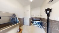 Located at 168 Headwater Circle in Mooresville, NC, this single-room professional pet grooming space is purpose-built to accommodate the full range of grooming needs. The room is thoughtfully designed with both functionality and durability in mind, featuring large-format gray tile wainscoting that lines the lower portion of all walls, providing a moisture-resistant and easy-to-clean surface. The upper walls are finished in crisp white, creating a clean and bright atmosphere.

At the heart of the space is a stainless steel professional pet bathing tub, complete with an integrated step, spray attachments, and restraint hardware — ideal for bathing pets of various sizes. Opposite the tub, a hydraulic scissor-lift grooming table with an overhead grooming arm and leash restraints allows for ergonomic and efficient styling work. A wall-mounted professional pet dryer provides convenient, hands-free drying capability.

The flooring is a light-toned, easy-to-maintain surface suited for a high-use grooming environment. A windowed exterior door floods the room with natural light while providing direct exterior access, a practical feature for bringing pets in and out. The space also includes an interior door connecting to the broader facility. Overhead flush lighting ensures consistent illumination throughout. This well-equipped grooming room offers a professional, hygienic, and efficient environment for pet care services.