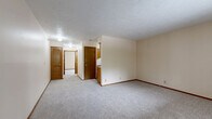 Located at 7319 Wirt Circle in Omaha, Nebraska, this 2-bedroom, 1-bathroom unit offers a straightforward single-floor layout designed for comfortable everyday living. The floor plan flows efficiently, connecting the living area, kitchen, and bedrooms with ease of access throughout.

The spacious primary bedroom is a standout feature, offering generous room for furnishings and is complemented by a large sliding double-door closet with warm wood-toned paneling, providing substantial storage space. A second bedroom features plush carpeting and a window dressed with vertical blinds, allowing natural light to filter into the room. Both bedrooms are finished with neutral cream-toned walls, wood baseboards, and textured ceilings.

The living area is open and airy, with soft carpeting underfoot and neutral walls that provide a clean, versatile backdrop. The kitchen is equipped with wood-toned cabinetry and a white range, offering a compact yet functional cooking space. The bathroom features a shower/tub combination with a stylish patterned curtain, a toilet, and hard surface flooring. Additional features throughout include track lighting, wall sconces, and louvered interior doors that add a classic touch to the overall aesthetic.