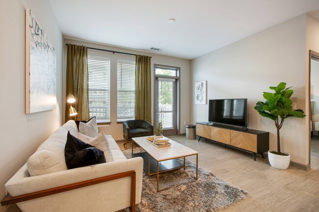 Living Room with Gorgeous Hardwood-Style Flooring - Vesta City Park Apartments