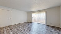 Located at 6602 E Harry St in Wichita, Kansas, this single-floor unit offers a clean, functional layout designed for comfortable everyday living. The main living area features light-toned wood-look flooring and a large sliding glass door fitted with vertical blinds, allowing abundant natural light to fill the space while providing direct access to an outdoor patio. A ceiling fan adds both style and practicality to the adjoining entry area, which shares the same wood-look flooring.

The galley-style kitchen is outfitted with warm oak cabinetry, dark laminate countertops, tile backsplash, and tile flooring, providing ample storage and counter workspace. A full-size refrigerator is included.

The bedrooms are carpeted in neutral tones and feature textured ceilings and windows with blinds that invite natural light. Closet space is well-considered, with at least one bedroom offering a wide sliding-door closet with a full-width hanging rod. The bathroom includes a double-sink vanity with oak cabinetry, large mirrors, and tile flooring, connecting conveniently to the adjacent carpeted bedroom. Throughout the unit, white walls and textured ceilings create a bright, neutral backdrop well-suited for a variety of interior styles.