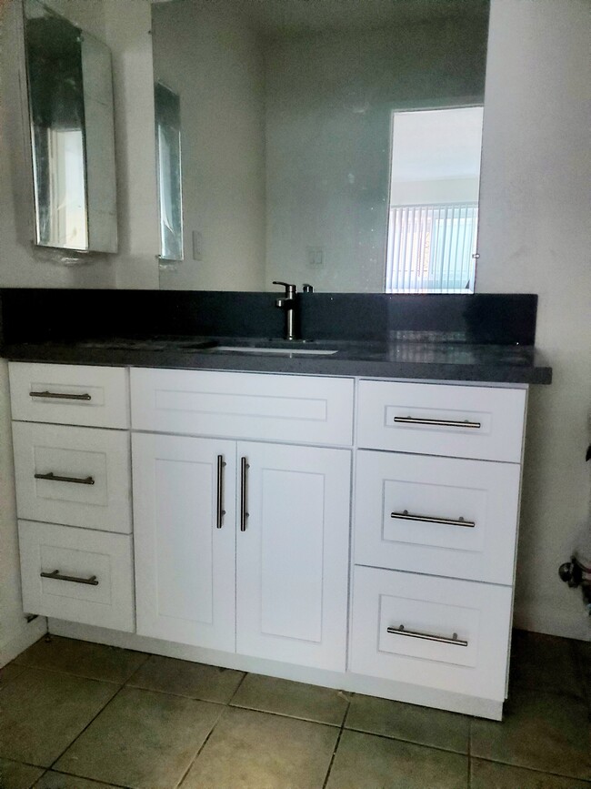 New countertops and cabinets in bathrooms - 3455 Elm Ave