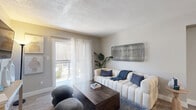Located at 10007 N 7th St in Phoenix, AZ, this thoughtfully designed one-bedroom, two-bathroom residence offers a comfortable and functional single-floor layout. Wood-look plank flooring runs throughout, creating a cohesive and easy-to-maintain aesthetic across every room.

The living room serves as the heart of the home, featuring a textured ceiling, ceiling fan, and a sliding glass door that opens to a private patio, allowing natural light to fill the space. A dedicated dining area sits just adjacent, making the open-concept layout ideal for everyday living and entertaining.

The kitchen is well-appointed with crisp white cabinetry, light quartz-style countertops, black appliances including a range, built-in microwave, and refrigerator, plus ample counter and storage space along both sides of the galley-style layout.

The bedroom offers a cozy and restful atmosphere, highlighted by a textured accent wall, a window with natural light, and dedicated closet space. Two full bathrooms serve the unit, one featuring an extended white vanity with sleek hardware, and the other including a full tub-shower combination — both finished with clean, neutral tones and wood-look flooring. This residence combines practical design with a warm, modern character ideal for comfortable Phoenix living.