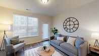 Located at 3986 Parkmead Dr in Grove City, Ohio, this well-appointed single-floor residence offers a thoughtfully designed open-concept layout that seamlessly connects the main living areas. The living room is bright and welcoming, featuring durable wood-look flooring, a large window with exterior door access that allows generous natural light to fill the space, and neutral-toned walls that create a clean, modern aesthetic.

The kitchen is a standout feature, equipped with rich dark-espresso cabinetry, light granite countertops, stainless steel appliances including an electric range, microwave, and refrigerator, and a central island with bar seating — ideal for both everyday meals and entertaining. Recessed lighting overhead enhances the functional elegance of the space.

The bedrooms are carpeted for comfort, each offering a calm, neutral palette and closet storage. The primary bedroom includes access to a spacious walk-in closet outfitted with wire shelving systems for organized storage. The bathroom is well-appointed with dark cabinetry, granite countertops, a large vanity mirror, and a glass-enclosed walk-in shower, all set on wood-look flooring that ties the space together cohesively.

Throughout the home, consistent finishes and a neutral color scheme create a harmonious and move-in-ready environment.