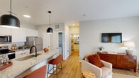 Located at 780 Doss Dr in Marysville, OH, this well-appointed one-bedroom, one-bathroom residence offers a thoughtfully designed layout with modern finishes throughout. The open-concept kitchen and living area serves as the heart of the home, featuring granite countertops, white cabinetry, stainless steel appliances including a refrigerator, microwave, and electric range, and a breakfast bar with pendant lighting — ideal for casual dining. Light wood-style flooring flows through the main living areas, lending a warm, cohesive feel.

The living room is bright and inviting, with large windows that welcome natural light and provide outdoor views, alongside a private exterior door. Neutral-toned walls complement the airy atmosphere throughout.

The bedroom is a comfortable retreat with plush carpeting, dual windows overlooking the outdoors, and direct access to a spacious walk-in closet outfitted with wire shelving systems for generous storage. An in-unit stacked washer/dryer is also conveniently located nearby.

The bathroom features wood-style flooring, a white vanity with granite countertop, and modern light fixtures. Clean lines and neutral tones carry through every room, creating a consistent, contemporary aesthetic that is both functional and welcoming.