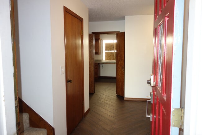 Inside the front door, Stairs to the left, kitchen straight ahead, and Master bedroom hall right - 7116 S Indianapolis Ave