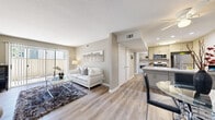 This thoughtfully designed single-story unit in Vacaville, CA (95687) offers a functional open-concept layout that maximizes its comfortable footprint. Light wood-tone flooring flows throughout the main living areas, creating a cohesive and bright atmosphere. The living room serves as the central gathering space, featuring a sliding glass door with vertical blinds that floods the room with natural light and provides access to an outdoor area with exterior views.

The kitchen is efficiently designed with granite countertops, gray shaker-style cabinetry, stainless steel appliances including a gas range, microwave, and refrigerator, and a peninsula that provides additional workspace and casual dining potential. Adjacent to the kitchen, a dedicated dining area offers additional flexibility.

The bedroom features carpeted flooring, a window with outdoor views, and access to a walk-in closet equipped with built-in hanging rods. A dedicated office space also features carpet and ample room for a full workstation setup. The bathroom includes a granite-topped vanity with gray cabinetry, a lighted mirror, and in-unit laundry access. Neutral wall tones and consistent finishes throughout contribute to a clean, modern aesthetic.