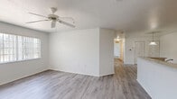 Located at 4601 Bristol Bay Way in Tampa, FL, this single-floor, 3-bedroom, 2-bathroom home offers a practical and well-organized layout. The living area features light gray wood-look flooring, a ceiling fan, and a large window that lets in natural light, creating a bright and airy atmosphere.

The kitchen is equipped with warm-toned wood cabinetry, light countertops with a peninsula-style breakfast bar, a double-basin sink, a white refrigerator, and a white electric range. Wood-look flooring extends through the kitchen, which also provides access to a dedicated laundry area.

All three bedrooms are carpeted for comfort. The generously sized primary bedroom includes a walk-in closet with built-in shelving and hanging space. The two secondary bedrooms each feature louvered bifold closet doors, ceiling fans, and clean white walls. Both bathrooms are finished with white tile tub-shower surrounds, chrome fixtures, wood-look flooring, and warm wood vanity cabinetry. A hallway connects the bedrooms and bathrooms, contributing to a logical and efficient floor plan. The home's clean, neutral palette throughout provides a versatile canvas suitable for a variety of living arrangements.