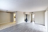 Located at 4861 N Blackwelder Ave in Oklahoma City, Oklahoma, this single-story, one-bedroom, one-bathroom home offers a well-organized layout across a compact and functional floor plan. The living room is bright and welcoming, featuring wood-look laminate flooring, a ceiling fan with light fixture, and large windows with blinds that invite an abundance of natural light. A sliding glass door provides additional outdoor access and further enhances the open, airy feel of the space. The kitchen features tile flooring, white cabinetry, light countertops, and includes a full-size refrigerator. A set of double doors within the kitchen provides convenient storage or pantry access. The generously sized primary bedroom is carpeted for comfort and includes a ceiling fan, a window for natural light, and two closet doors offering substantial storage. The bathroom features a marble-patterned vanity countertop, white cabinetry, a wall-mounted light fixture, and a separate enclosed area with a toilet and bathtub. Neutral warm-gray tones throughout the home, textured ceilings, and clean white trim create a cohesive and understated aesthetic that is easy to personalize.