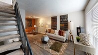Located at 4900 Bryant Irvin Rd N in Fort Worth, TX, this two-story residence offers a well-designed layout spread across two evenly divided floors. The main level features an open-concept living, dining, and kitchen area finished with durable wood-look hardwood flooring. The living room is bright and welcoming, with a large window that fills the space with natural light, textured ceilings, and ample room for comfortable furnishings. A distinct accent wall adds a bold pop of color to the adjacent dining area, creating a lively, defined space perfect for entertaining.

The upper level is home to the generously sized primary bedroom, which is carpeted for warmth and comfort. A ceiling fan keeps the room well-ventilated, and a large window allows for abundant natural light and views of the surrounding area. Three closets throughout the home provide excellent storage capacity.

The full bathroom features a clean, modern vanity with a white quartz countertop, an undermount sink, white cabinetry, and a large dark-framed mirror, all accented by bright overhead lighting. A staircase connects the two floors, completing the functional two-story design. This residence combines practical layout with comfortable finishes, making it an ideal space in the heart of Fort Worth.