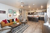 Located at 8225 Dorado Dr in Odessa, TX, this single-floor residence offers a thoughtfully designed layout with modern finishes and an inviting open-concept floor plan. The kitchen serves as a central hub, showcasing rich dark cabinetry, granite countertops, a large island with bar seating and pendant lighting, a white subway tile backsplash, and a full suite of stainless steel appliances. Wood-look plank flooring extends through the kitchen and living areas, adding warmth and continuity throughout.

The living room is bright and welcoming, with multiple windows that invite natural light and provide outdoor views. A private entry door leads directly from the living space, enhancing accessibility and convenience.

Both bedrooms are well-sized and carpeted, each featuring multiple windows with ample natural light and ceiling fans. The primary bedroom connects to a bathroom with granite-topped dark cabinetry and direct access to a walk-in closet with built-in shelving. A second full bathroom includes a tub-shower combination, granite vanity, and additional overhead cabinetry.

The overall aesthetic is contemporary and cohesive, with a neutral gray palette, clean lines, and consistent use of dark wood tones and granite surfaces tying the spaces together seamlessly.