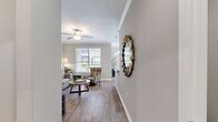 Located at 9404 West Rd in Houston, TX, this well-appointed one-bedroom, one-bathroom residence offers a comfortable and functional single-floor layout. Warm wood-style flooring runs throughout, complemented by neutral gray walls and white trim that create a clean, cohesive aesthetic.

The open-concept living and dining area is bright and welcoming, with large windows dressed in horizontal blinds that invite natural light and offer views of the landscaped courtyard. Crown molding adds a refined touch to the dining space, which flows seamlessly into the kitchen. The kitchen features white shaker-style cabinetry, granite-look countertops, a full suite of stainless steel appliances, and ample storage — ideal for everyday cooking and entertaining.

The bedroom is generously sized with a ceiling fan, a bright window, and direct access to the spacious walk-in closet, which is outfitted with wire shelving on multiple walls for organized storage. The full bathroom impresses with a double-sink vanity, white cabinetry with granite countertops, a large mirror, and a soaking tub with a shower.

A private balcony extends the living space outdoors, overlooking a well-maintained green courtyard. The hallway connects all areas efficiently, completing this thoughtfully designed home.