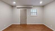 Located at 3716 Cliffside Drive Northeast in Cleveland, Tennessee, this well-appointed one-bedroom, two-bathroom home offers a practical and comfortable single-floor layout. The open-concept living and kitchen area forms the heart of the home, with warm hardwood-style flooring running throughout and recessed lighting illuminating the space. The kitchen is outfitted with a full suite of stainless steel appliances — including a side-by-side refrigerator with ice maker, electric range, built-in microwave, and dishwasher — complemented by rich dark cabinetry, light granite-style countertops, and a deep double sink. The adjacent living room is spacious and bright, featuring a ceiling fan and a paneled entry door alongside a window that brings in natural light. The bedroom is generously sized, complete with a ceiling fan, a large closet, and a window dressed with blinds. Two bathrooms serve the home, with one featuring dark wood cabinetry, a granite-topped vanity, a framed mirror, and a tub-shower combination. A dedicated laundry room houses a full-size washer and dryer, adding everyday convenience. Clean neutral tones and consistent flooring create a cohesive, move-in-ready aesthetic throughout.