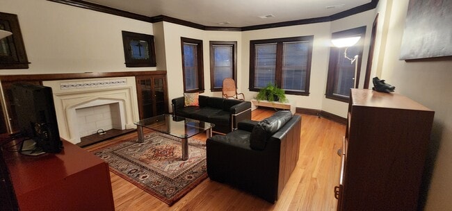 Living Room with leather couch and armchair, rocking chair, glass table, credenza, cabinets, lamps - 2018 Lake St