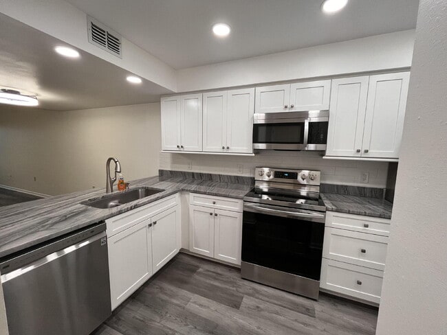 Building Photo - Two-story condominium, featuring 2 bedrooms and 2 1/2 bathrooms