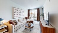 This thoughtfully designed one-bedroom, one-bathroom residence at 3300 Toledo Rd in Hyattsville, MD offers a comfortable and modern living experience across a well-utilized single floor. The open-concept layout seamlessly connects the kitchen, dining, and living areas, creating an airy and cohesive flow throughout the space. The contemporary kitchen is a standout feature, showcasing sleek light grey cabinetry extending to the ceiling, white quartz countertops, a classic subway tile backsplash, stainless steel appliances including a gas range, built-in microwave, dishwasher, and refrigerator, and a kitchen island illuminated by stylish pendant lighting. Rich hardwood-style flooring runs throughout the main living areas. The living room is bright and welcoming, benefiting from large windows that frame neighborhood views and invite abundant natural light. The bedroom is a tranquil retreat, offering generous proportions, large windows with exterior views, and ample closet storage. The bathroom features a clean, all-white tiled tub-shower combination. Additional highlights include a private balcony, dedicated laundry, and two closets, making this residence as functional as it is stylish.