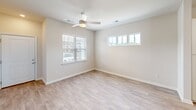 Located at 270 Wild Palm Way in Conway, SC, this well-designed single-story home offers a bright and functional layout across a comfortable footprint. The open-concept kitchen and living area serves as the heart of the home, featuring light-toned luxury vinyl plank flooring, recessed lighting, and a ceiling fan that enhances air circulation throughout the space. The kitchen is thoughtfully appointed with crisp white shaker cabinets, granite countertops, a subway tile backsplash, stainless steel appliances including a refrigerator, range, microwave, and dishwasher, and a central island with additional shelving. A built-in desk or workspace area adds a practical touch to the layout. The living room is filled with natural light from multiple windows, including a charming transom-style window. The bedroom is a comfortable retreat with plush carpeting, a ceiling fan, and a window with blinds. It connects to a walk-in closet with wire shelving and direct access to the bathroom. The bathroom features a granite-topped vanity, wood-look tile flooring, and a glass-enclosed shower and tub combination. The overall aesthetic is clean, modern, and move-in ready.