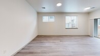 Located at 1809 Linwood Dr NW in Salem, Oregon, this two-story home offers a well-organized layout across two floors. The ground level hosts a welcoming entrance that flows into an open-concept space combining the living room, dining area, and kitchen. The kitchen is a standout feature, equipped with stainless steel appliances, dark wood cabinetry, a white quartz countertop island, and stylish pendant lighting, all set above light wood-style flooring. An attached garage with a built-in opener and water heater provides direct interior access, while a dedicated laundry room houses a full-size washer and dryer. Carpeted staircases connect both floors, accented by clean white railings and light-toned walls throughout. The upper floor contains all four bedrooms, including a primary bedroom with a closet and direct access to adjacent rooms, along with three bathrooms finished with dark wood vanities and white countertops. Additional bedrooms are bright and comfortable, featuring neutral carpet, natural light from multiple windows, and ample closet space. Five closets distributed across the home ensure generous storage. The overall aesthetic is modern and clean, with a consistent palette of neutral tones, light flooring, and contemporary finishes throughout.
