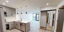 This 490 square foot one-bedroom apartment offers a thoughtfully designed living space with contemporary finishes throughout. The open-concept floor plan seamlessly integrates the living room, dining area, and kitchen, creating a sense of spaciousness within the compact layout. The kitchen boasts modern grey cabinetry, stainless steel appliances, and a white quartz countertop with a breakfast bar.

The bedroom, measuring 110 square feet, features a large closet with sliding doors and is illuminated by a unique globe light fixture. Floor-to-ceiling windows in both the living area and bedroom flood the space with natural light and provide stunning city views. Light-toned hardwood flooring runs throughout, enhancing the bright and airy ambiance.

The bathroom, while compact, is efficiently designed with a modern vanity and clean white fixtures. Two additional closets offer ample storage space. A notable feature is the private balcony accessible through sliding glass doors, extending the living space outdoors.

Located at 110 Fullarton, unit 2105, this apartment combines functionality with style, making efficient use of its 490 square feet to create a comfortable urban living environment.