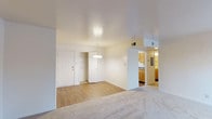 This single-floor residence at Park Lake offers a practical and comfortable layout designed for everyday living. The open living and dining area serves as the heart of the home, featuring a combination of plush carpet and wood-look flooring, a pendant light fixture over the dining space, and a closet near the entryway. Large white walls and smooth ceilings contribute to a bright, clean ambiance throughout.

The galley-style kitchen is efficiently designed with warm wood cabinetry, dark countertops, a stainless steel sink, and white appliances including a coil-top range and refrigerator. Wood-look flooring runs through the kitchen, adding warmth to the space.

The bedrooms are carpeted and feature neutral walls, providing a versatile canvas for personalization. Several rooms include windows with blinds that allow natural light to filter in, and at least one bedroom includes an adjacent door for added convenience.

Two bathrooms serve the unit — one full bath with a tub-shower combination, toilet, and single vanity, and a second half-bath featuring a wood-cabinet vanity with a lighted mirror and dark hardwood-style flooring. The layout is completed by a secondary entry door, offering additional access to the unit.