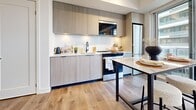 Located at 75 Broadway Ave in Toronto's Midtown neighbourhood, this thoughtfully designed 2-bedroom, 2-bathroom unit offers a contemporary living experience across a well-utilized single floor. The open-concept kitchen and living area serves as the heart of the home, featuring light wood-grain cabinetry, white quartz countertops, stainless steel appliances, and warm hardwood-style flooring throughout. The living room is bathed in natural light through expansive floor-to-ceiling windows that open onto a private balcony, offering sweeping city views. Both bedrooms are generously proportioned with large windows that continue the theme of natural light and urban outlook. The primary bedroom is a comfortable retreat with ample storage. The two bathrooms are finished to a high standard, featuring large-format grey marble-effect tiles. One bathroom includes a deep soaker tub with matching tiled surround, while the second features a glass-enclosed walk-in shower with matte black fixtures. Hallways connect the spaces efficiently, with a practical layout that maximizes every square foot. The overall ambiance is clean, modern, and bright — a well-appointed urban residence ideal for those seeking comfort and style in the heart of Toronto.