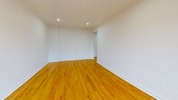 Located on the third floor of a classic red-brick building in Montreal, this one-bedroom, one-bathroom unit offers a well-organized layout across a single floor. Warm-toned hardwood floors run continuously throughout the living spaces, reflecting natural light and lending a cohesive, inviting feel to the interior.

The living room is the most spacious area of the unit, featuring recessed pot lighting, clean white walls, and a window that provides views of the surrounding neighbourhood and mature trees. A baseboard heating unit ensures comfortable year-round living. The open sightlines between the living room and the hallway contribute to an efficient, uncluttered flow throughout the space.

The bedroom is a well-proportioned private retreat, also finished with the same hardwood flooring and recessed lighting. Its white walls and simple layout offer versatility for furnishing arrangements.

The bathroom stands out as a visually distinct space, featuring floor-to-ceiling marble-effect tile in rich brown and grey tones. A full soaking tub, vanity with sink, toilet, and a frosted privacy window complete the room, giving it a refined, spa-like character relative to the unit's overall scale.

The building exterior features classic brick construction, and the balcony offers views of neighbouring rooftops and greenery.