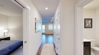Located at 95 Newport Ave in East Providence, RI, this well-appointed one-bedroom, one-bathroom residence offers a thoughtfully designed single-floor layout. A bright, recessed-lit hallway with rich hardwood flooring and clean white walls serves as the central corridor connecting all rooms, setting a modern and welcoming tone throughout.

The open-plan kitchen and living area forms the heart of the home. The kitchen features dark espresso cabinetry, white quartz countertops, a classic white subway tile backsplash, stainless steel appliances — including a range, microwave, and dishwasher — and a window that fills the space with natural light. The adjoining living room offers hardwood floors, a wall-mounted mini-split HVAC unit, and windows with blinds providing ample daylight and a comfortable atmosphere.

The bedroom is carpeted for warmth and comfort, includes a dedicated closet, and is equipped with its own mini-split HVAC unit for independent climate control. The full bathroom showcases a classic black-and-white hexagonal tile floor, a dark-cabineted vanity with white countertop, and crisp white walls that give it a timeless, clean aesthetic. Together, these spaces create an efficient and stylishly finished residence ideal for modern living.