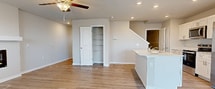 This two-story property in Ankeny, Iowa, offers a blend of modern amenities and practical features. The home boasts a spacious garage with a high ceiling, ample floor space, and an automatic door opener, providing secure parking and potential storage options. The bathroom is well-appointed, featuring a combination bathtub and shower with built-in shelving, complemented by a modern toilet and towel rack.

The laundry area is equipped with a side-by-side washer and dryer set, topped with a convenient wire shelf for storage. A generously sized walk-in closet with wall-to-wall wire shelving offers abundant storage space. The living area showcases an inviting ambiance with a modern electric fireplace, ceiling fan, and large windows that allow natural light to flood the room.

The kitchen is a highlight, featuring sleek white cabinetry, stainless steel appliances, and a central island, all set against warm hardwood flooring. Bedrooms are carpeted for comfort, with ample closet space and windows for natural light. The property's layout, as seen in the 3D model, reveals an efficient use of space with well-connected rooms. Throughout the home, neutral tones dominate, creating a bright and airy atmosphere that allows for personalized decor. This property combines functionality with modern design, offering a comfortable living space in a desirable location.