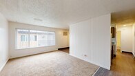 Located at 1820 Ethan Way in Sacramento, CA, this one-bedroom, one-bathroom unit offers a practical and functional single-floor layout. The living room is a bright, open space featuring neutral-toned carpet, a textured ceiling, vertical blind-covered windows that allow natural light to filter in, and a wall-mounted air conditioning unit for climate control. A distinctive white vertical-panel accent wall adds a subtle design element to the living area, which transitions to wood-style vinyl flooring toward the kitchen and hallway. The galley-style kitchen is well-appointed with gray cabinetry, granite-style countertops, a double-basin sink, and stainless steel appliances including a refrigerator, electric range, and dishwasher — all finished with wood-look flooring. The bedroom is a comfortable, carpeted retreat featuring a large wall of sliding double closets offering generous storage, a window with vertical blinds, and a textured ceiling consistent with the rest of the unit. The bathroom includes a full-size soaking tub with an overhead shower and clean, light-toned surround walls. Throughout the unit, the neutral color palette and practical finishes create a clean, move-in-ready environment.