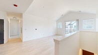 Located at 3223 W 111th St in Naperville, IL, this thoughtfully designed single-floor home offers three bedrooms, two bathrooms, and a well-appointed layout that maximizes comfort and functionality. Light-toned hardwood flooring flows throughout, creating a bright and cohesive aesthetic across all rooms.

The open living area features vaulted ceilings that lend a sense of spaciousness, with a sliding glass door providing access to a private balcony and filling the space with natural light. The kitchen is a standout feature, showcasing white shaker cabinetry, a striking marble-look quartz countertop and island with a matte black faucet, a subway tile backsplash, stainless steel appliances, and pendant track lighting overhead.

The primary bedroom is generously sized and includes a walk-in closet outfitted with built-in shelving and drawers for organized storage. Additional bedrooms are clean and well-proportioned, complemented by stylish slate-gray paneled doors with matte black hardware throughout the home. The bathrooms feature white subway tile tub surrounds, white vanities, and consistent matte black fixtures. A dedicated laundry room with a full-size washer and dryer adds everyday convenience to this polished, move-in-ready home.