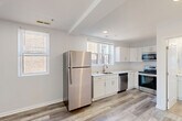 Located at 1101 Euclid St NW in Washington, DC, this efficiently designed 3-bedroom, 1-bathroom unit offers a thoughtfully updated interior with modern finishes throughout. Light-toned, wood-style flooring runs continuously across the entire space, complementing the crisp white walls and creating a clean, cohesive aesthetic.

The open-concept kitchen, dining, and living area serves as the heart of the unit. The kitchen is well-appointed with white shaker-style cabinetry, light quartz countertops, and a full suite of stainless steel appliances, including a refrigerator, electric range, over-the-range microwave, and dishwasher. Multiple windows invite generous natural light, adding brightness to the space.

The three bedrooms are compact yet functional, each featuring light-filled windows — with the primary bedroom benefiting from dual windows offering treetop views. The rooms maintain the same neutral palette and wood-style flooring found throughout.

The bathroom is finished with classic white subway tile surrounding the tub-shower combination, a white vanity with a framed mirror, and matching wood-style flooring, delivering a clean, contemporary feel. A dedicated closet and entrance area round out the layout, maximizing utility within the footprint of this conveniently located DC residence.