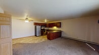 Located at 6856 Vicksburg Ln N in Maple Grove, Minnesota, this two-floor residence offers a practical and comfortable layout with consistent finishes throughout. The kitchen is a standout feature, equipped with rich dark cherry wood cabinetry, granite-look countertops, and a full suite of stainless steel appliances including a refrigerator, gas range, microwave, and dishwasher. Tile flooring in the kitchen transitions seamlessly into the carpeted living area, which includes a ceiling fan and open sightlines to the kitchen peninsula — ideal for everyday living. The bedrooms are generously sized, carpeted, and bathed in natural light through wood-trimmed sliding windows that offer views of the surrounding neighborhood and greenery. Baseboard heating is present throughout, ensuring year-round comfort. The bathrooms are clean and well-finished — one features a full tub-shower combo with updated fixtures and a vanity with a cultured marble top, while another includes rich cherry wood cabinetry with a tall linen tower for added storage. Textured ceilings are consistent across the space, contributing to the home's traditional character. Overall, the residence presents a cohesive, functional design well-suited for comfortable everyday living in a residential Maple Grove neighborhood.